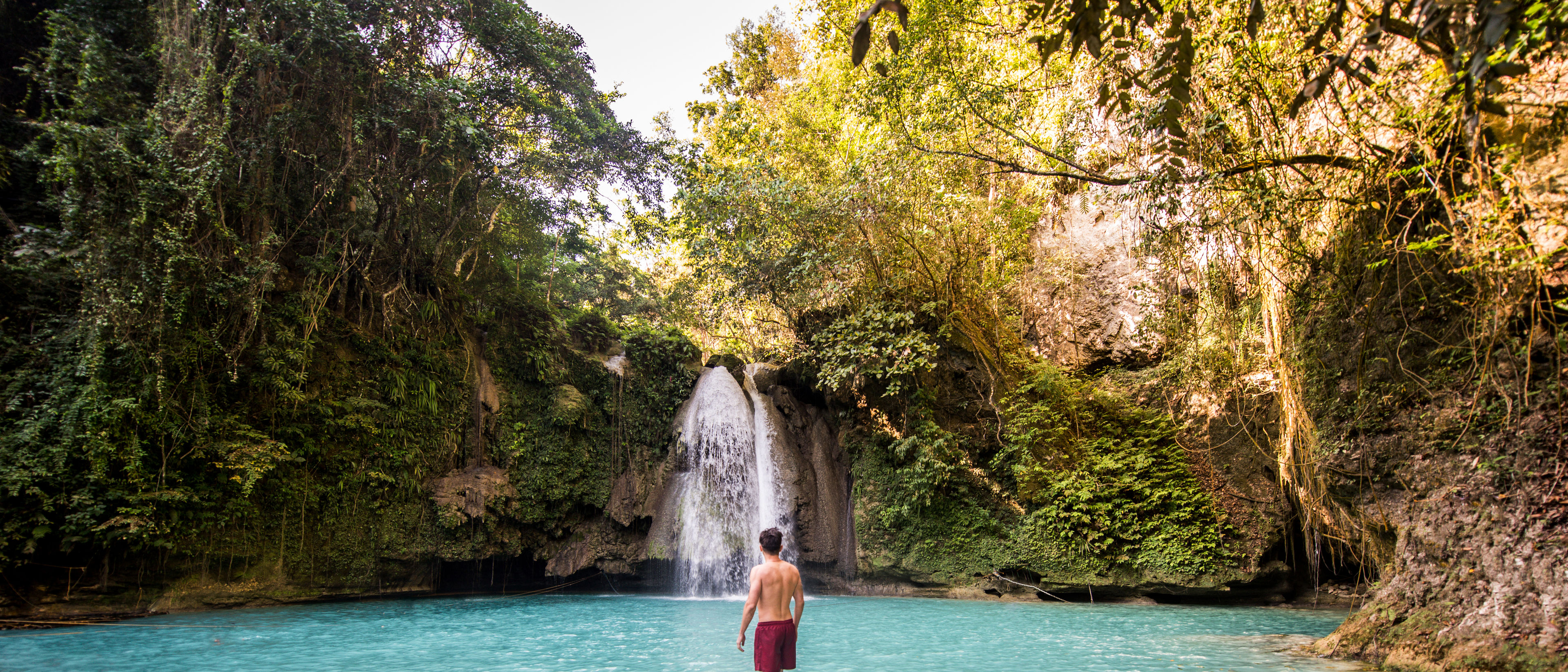 Man enjoying the waterfall.